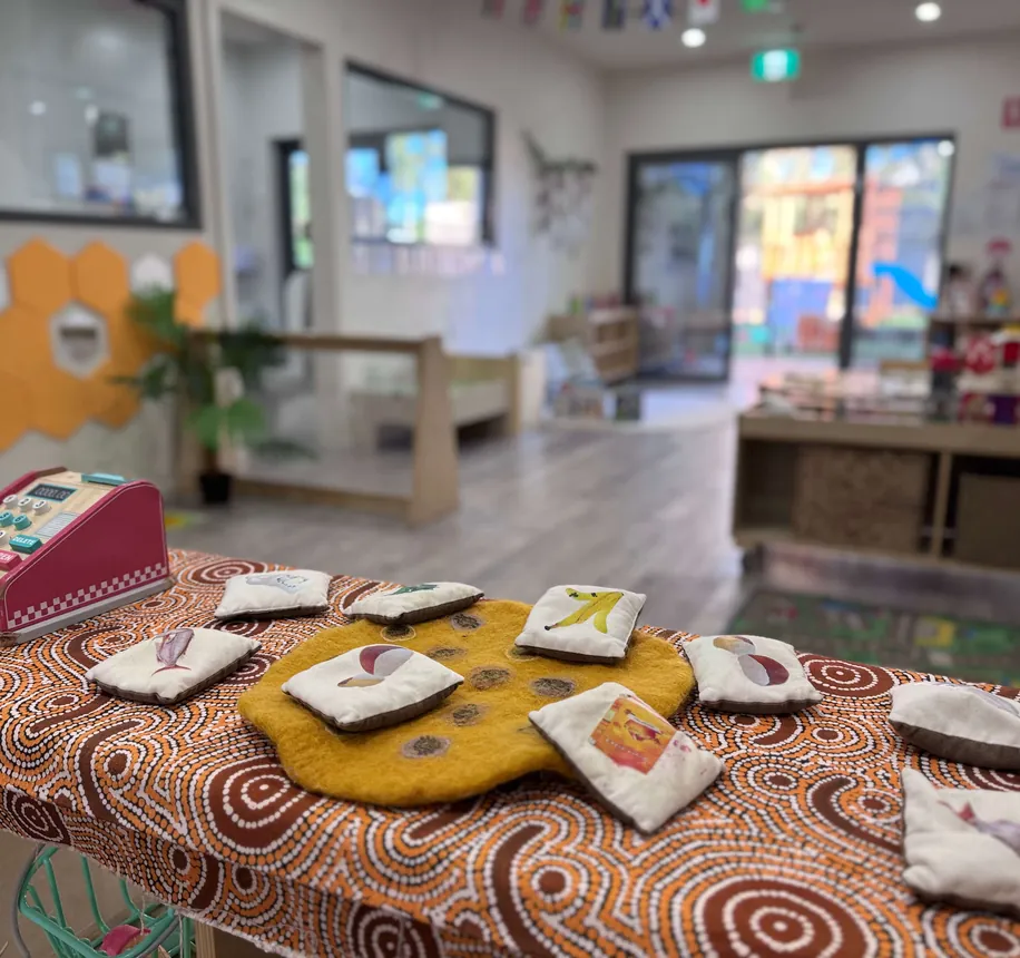 Indoor mat area set up with cultural resources and cushions